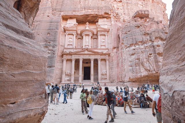 Visitors tour near the Treasury at the ruins of the ancient Nabataean city of Petra in southern Jordan on December 12, 2022 (AFP file photo)
