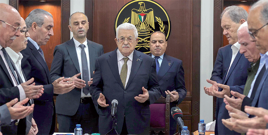 This handout photo released by the Palestinian Authority's Press Office shows President Mahmud Abbas (centre) leading prayers next to Palestine Liberation Organisation Secretary General Hussein Al Sheikh (3rd left) during a meeting of the organisation's Executive Committee in Ramallah on Saturday (AFP photo)
