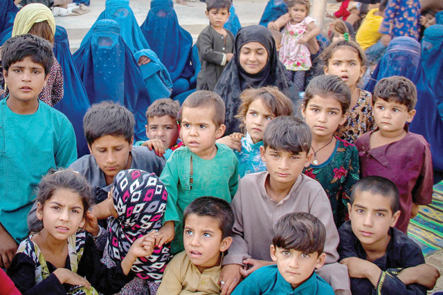 In this file photo children from the Internally displaced Afghan families arriving from districts of Khan Abad, Ali Abad and Imam Sahib who fled due to the ongoing battles between Taliban and Afghan security forces, look on inside the premises of a school in Kunduz city on June 26 (AFP photo)