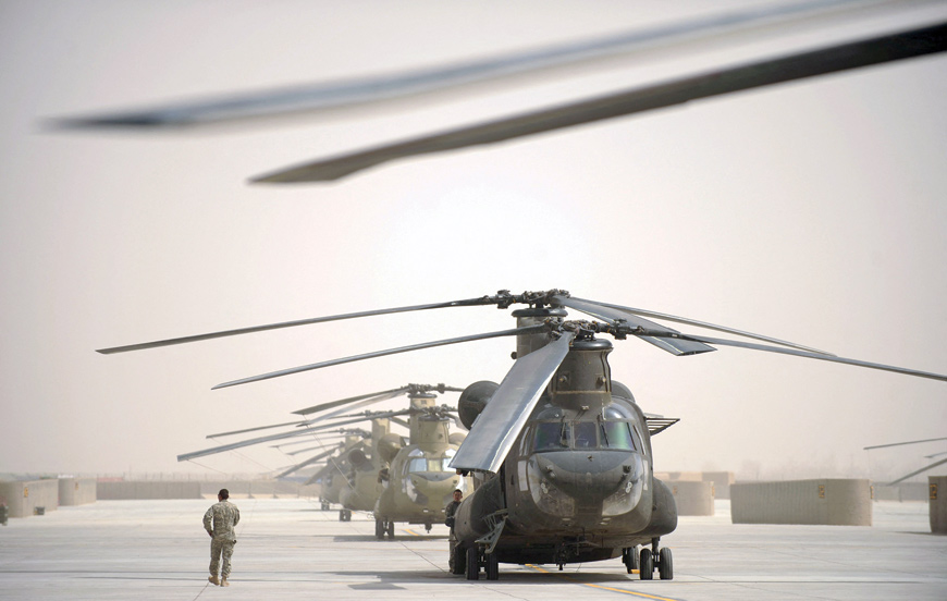 In this file photo taken on March 16, 2011, a US airman walks past a row of Chinook helicopters at Kandahar airbase in southern Afghanistan (AFP photo)