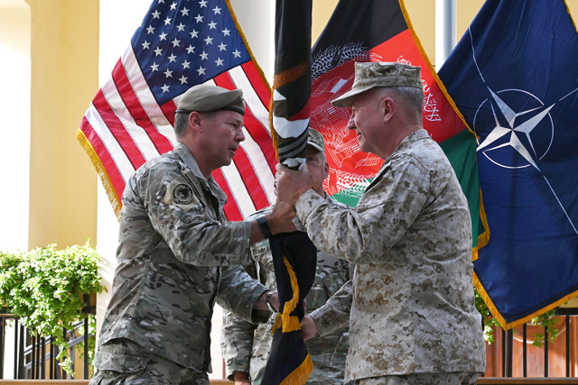 General Kenneth McKenzie (right), the head of US Central Command, receives the flag of US-led Resolute Support mission from General Austin 'Scott' Miller, US top commander of coalition forces in Afghanistan, during an official handover ceremony at the Resolute Support headquarters in the Green Zone in Kabul on Monday (AFP photo)