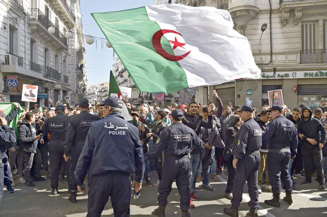 Members of the Algerian police block the progress of an anti-government demonstration heading towards the presidential palace in the capital Algiers on Saturday (AFP photo)
