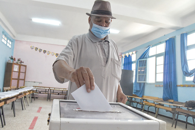A man casts his ballot at a polling station in Bouchaoui, on the western outskirts of Algeria's capital Algiers, on Saturday during the 2021 parliamentary elections (AFP photo)