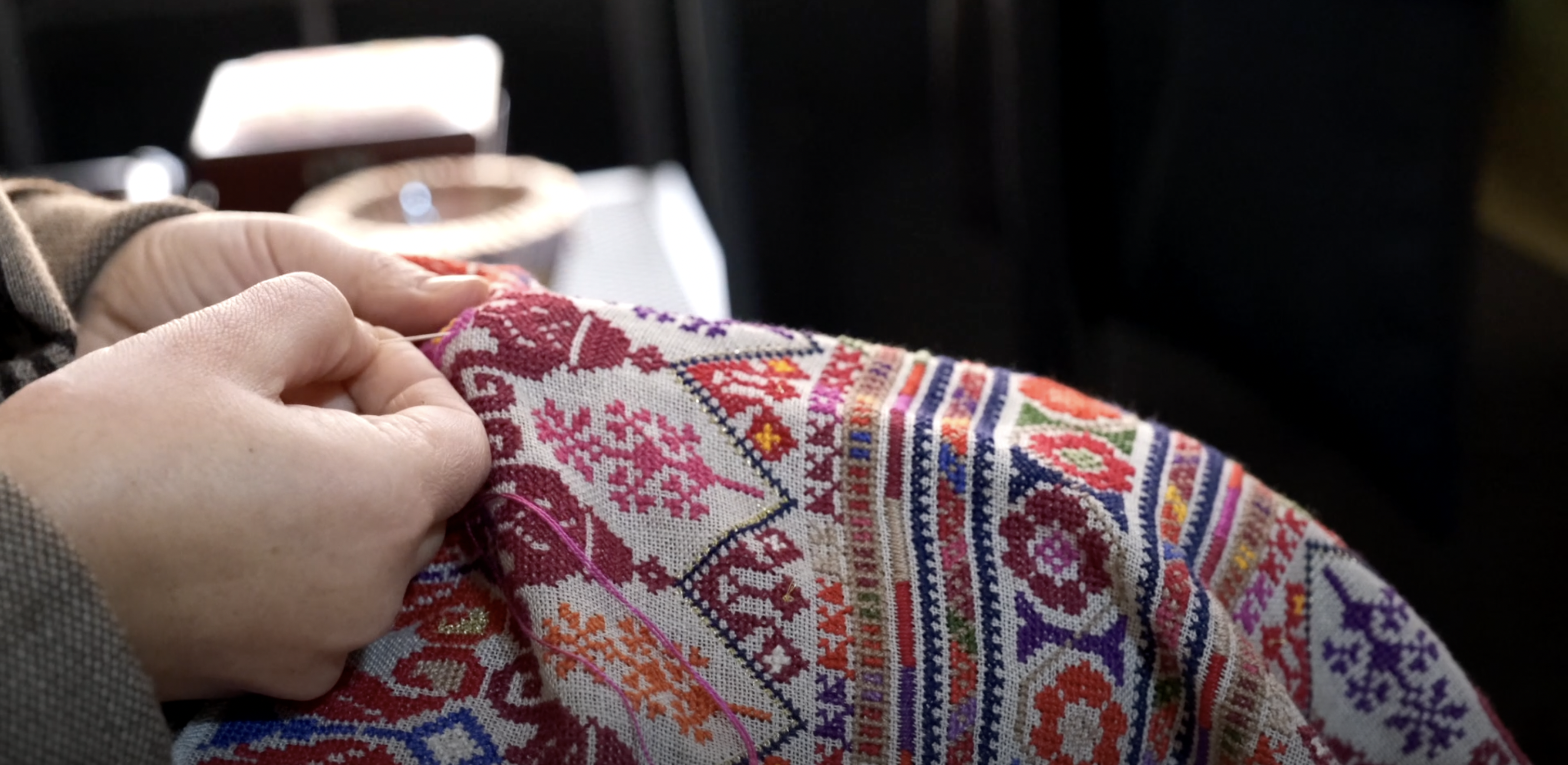 A volunteer at the Palestinian Culture Centre in Amman adds the finishing touches to a piece of traditional clothing in this recent photo (Photo by Anna Rice)