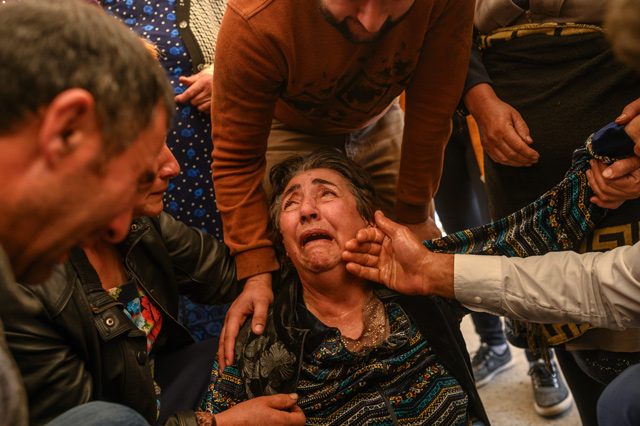 Relatives of Royal Sahnazarov, his wife Zuleyha Sahnazarova and their daughter Medine Sahnazorava, who were killed when a rocket hit their home, mourn during their funeral in the city of Ganja, Azerbaijan, on Saturday during fighting over the breakaway region of Nagorno-Karabakh (AFP photo)