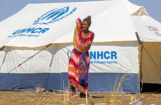 An Ethiopian refugee, who fled the Tigray conflict, walks in the Tenedba camp in Mafaza, eastern Sudan, on January 8, after being transported from the reception centre (AFP photo)