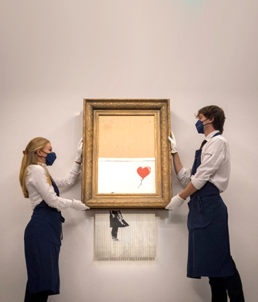 Shredded Banksy ‘Love is in the Bin’ canvas  (AFP photo by Tolga Akmen)