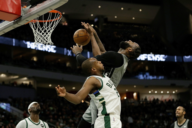 Andre Drummond of the Brooklyn Nets (right) is fouled by the  Milwaukee Bucks’ Wesley Matthews during their NBA game in Milwaukee, Wisconsin, on Saturday (AFP photo by John Fisher)