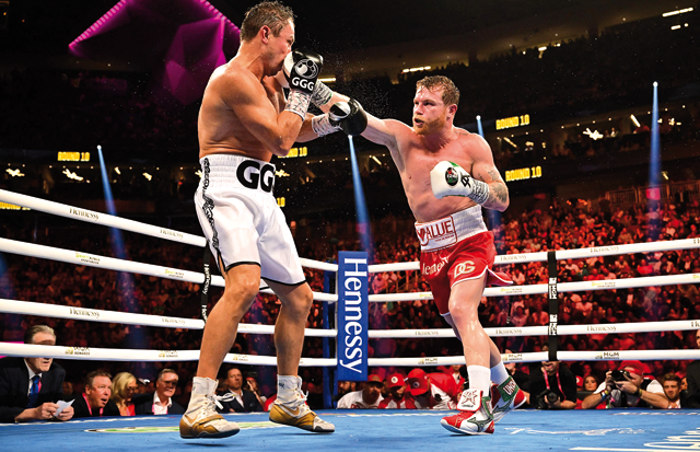 Mexican Saul Alvarez (right) and Kazakh Gennadiy Gennadyevich Golovkin exchange punches during their fight for the Super Middleweight boxing title in Las Vegas, Nevada, on Saturday (AFP photo by Frederic J. Brown)