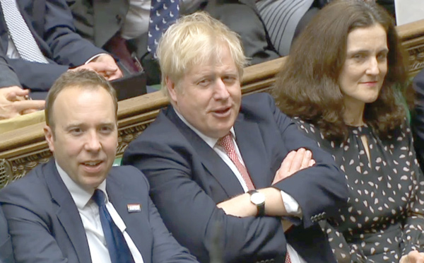 A video grab from footage broadcast by the UK Parliament's Parliamentary Recording Unit  shows Britain's Prime Minister Boris Johnson (centre) reacting after his Government won the vote on the third reading of the European Union (Withdrawal Agreement) Bill, in the House of Commons in London on Thursday (AFP photo)