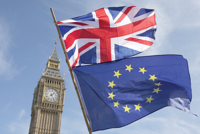 In this file photo taken on March 25, 2017 an EU flag and a Union flag are seen with Elizabeth Tower (Big Ben) and the Houses of Parliament in London (AFP photo)
