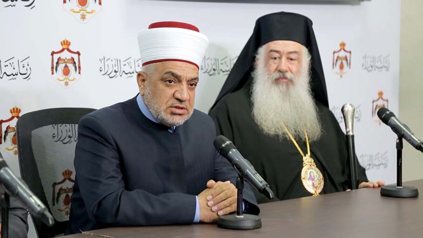 Awqaf Minister Mohammad Khalaileh, accompanied by President of the Jordan Churches Council Archbishop Christophorus Attallah, speaks during a briefing at the Prime Ministry in Amman on Thursday (Petra photo)