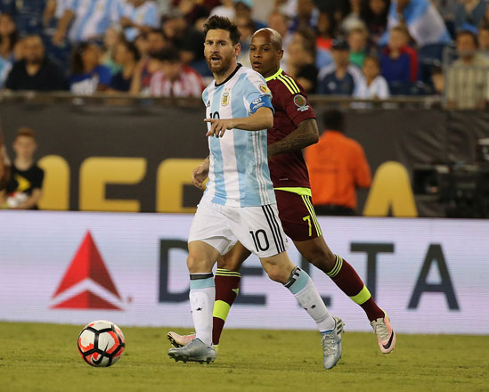 Lionel Messi of Argentina keeps the ball from Yonathan Del Valle of Venezuela during their 2016 Copa America quarter-final match on Saturday in Foxboro, Massachusetts  (AFP photo by Jim Rogash)