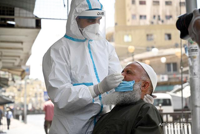 A member of the epidemiological cadre carries out a coronavirus test in downtown Amman in this recent photograph  (JT file photo)