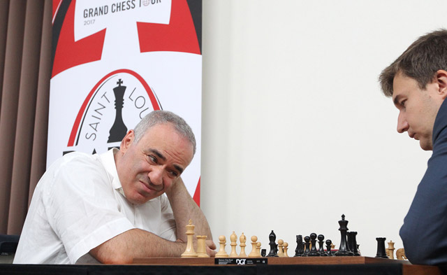 Grandmaster chess player Garry Kasparov (left) looks to make a move as he plays grandmaster Sergey Karjakin of Russia in the opening round of the Grand Chess Tour in St Louis on Monday  (AFP photo by Bill Greenblatt)