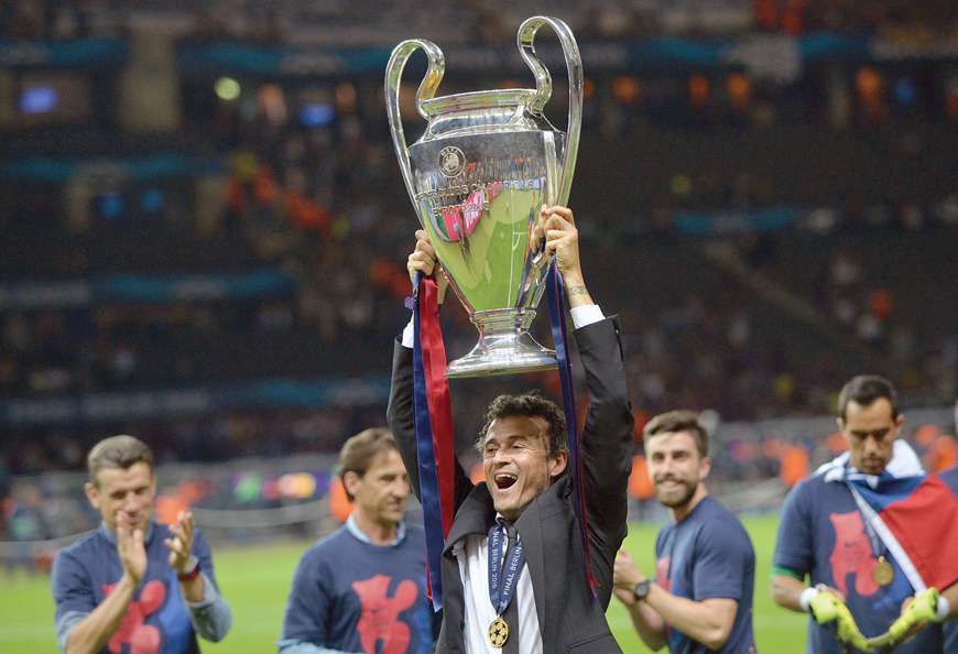 Barcelona’s coach Luis Enrique celebrates with the trophy after the UEFA Champions League final match against Juventus in Berlin on Saturday (AFP photo by Oliver Lang)