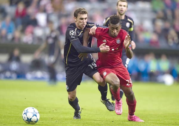 Dinamo Zagreb’s Croatian midfielder Josip Pivaric (left) and Bayern Munich’s French striker Kingsley Roman vie for the ball during their Group F, first-leg UEFA Champions League football match in Munich, on Tuesday (AFP photo by Guenter Schiffmann)