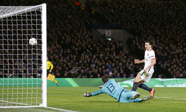 Paris Saint Germain’s Zlatan Ibrahimovic scores his sides second goal of the game past a diving Chelsea goalkeeper Thibaut Courtois during their Champions League round of 16 second leg match in London, on Wednesday (AP photo by Frank Augstein)