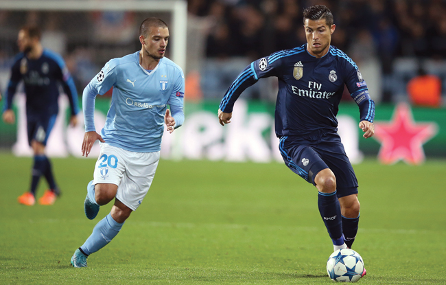 Malmo FF’s Vladimir Rodic vies for the ball with Real Madrid’s Cristiano Ronaldo during their Champions League Group A football match in Malmo, on Wednesday (AP photo by Andreas Hillergren)
