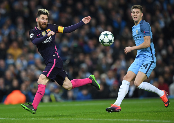 Barcelona’s Argentinian striker Lionel Messi (left) vies with Manchester City’s English defender John Stones during their UEFA Champions League Group C football match in Manchester, England, on Tuesday (AFP photo by Paul Ellis)