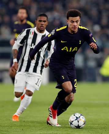Tottenham’s Dele Alli in action followed by Juventus’ Douglas Costa during their Champions League match in Turin, Italy, on Tuesday (Reuters photo by Paul Childs )