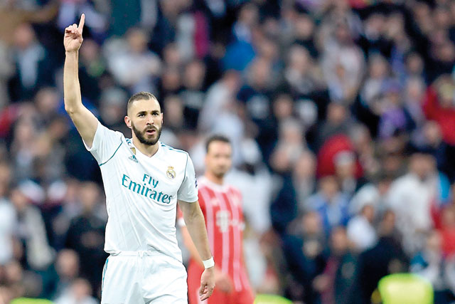 Real Madrid’s French forward Karim Benzema celebrates after scoring a goal during the UEFA Champions League semifinal second leg football match against Bayern Munich in Madrid on Tuesday  (AFP photo by Oscar Del Pozo) 