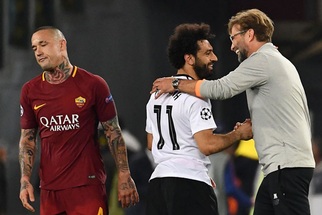 Liverpool’s Egyptian midfielder Mohamed Salah (centre) celebrates their victory with Liverpool’s German manager Jurgen Klopp at the end of their UEFA Champions League semifinal second leg match against Roma in Rome on Wednesday (AFP photo by Alberto Pizzoli)