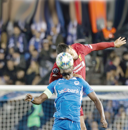 RC Genk’s Tanzanian forward Mbwana Ally Samatta (front) and Liverpool’s Dutch defender Virgil van Dijk head the ball as they vie for it during their UEFA Champions League Group E match in Genk on Wednesday  (AFP photo by Francois Walschaerts)