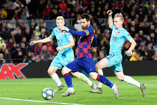 Slavia Prague’s Czech midfielder Petr Sevcik (right) challenges Barcelona’s Argentine forward Lionel Messi during their UEFA Champions League Group F football match in Barcelona on Tuesday (AFP photo by Lluis Gene)