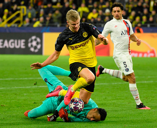 Dortmund’s Norwegian forward Erling Braut Haaland (centre) scores against Paris Saint-Germain’s Costa Rican goalkeeper Keylor Navas (bottom) during their UEFA Champions League Last 16, first-leg football match in Dortmund, Germany, on Tuesday  (AFP photo by Ina Fassbender)