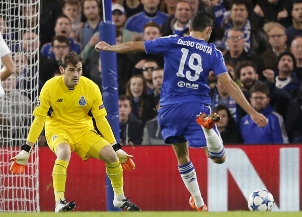 Chelsea’s Diego Costa (right) shoots to score next to Porto goalkeeper Iker Casillas (left) during their Champions League Group G football match in London on Wednesday (AP photo by Frank Augstein)