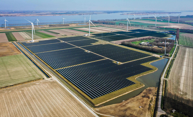 This aerial view taken in Middelharnis on Tuesday shows the Haringvliet energy park on Goeree-Overflakkee. The park consists of six windmills, 115 thousand solar panels and 12 sea containers full of batteries, which together form a large battery (AFP photo)