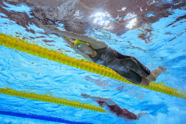 Australia’s Emma McKeon (right) competes to win in the mixed 4x100m freestyle relay swimming final at the Commonwealth Games in Birmingham, England, on Friday (AFP photo by Oli Scarff)  
