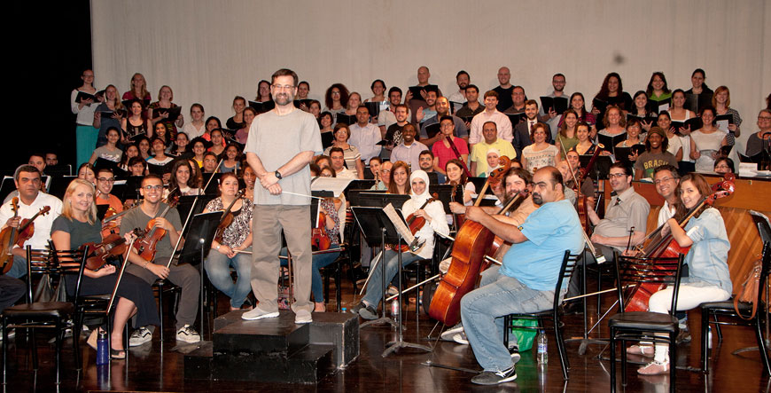 Conductor William Culverhouse with the musicians of JOrchesrtra and Dozan Wa Awtar singers rehearse on Monday evening at the International Academy in Amman (Photo by Jean-Claude Elias)