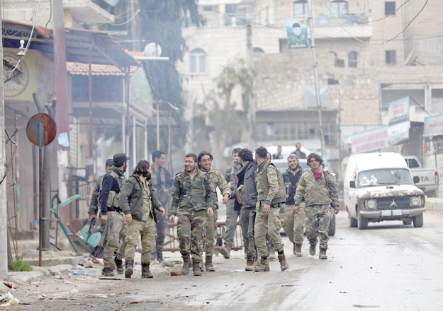 Turkish-backed Syrian Arab fighters walk in the Kurdish-majority city of Afrin after seizing control of the northwestern Syrian city from the Kurdish People's Protection Units on Sunday (AFP photo)