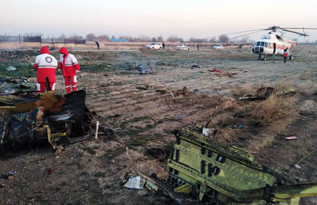 This handout photo provided by the Iranian Red Crescent on Wednesday shows rescue teams working at the scene after an Ukrainian plane carrying 176 passengers crashed near Imam Khomeini airport in the Iranian capital Tehran (AFP photo)