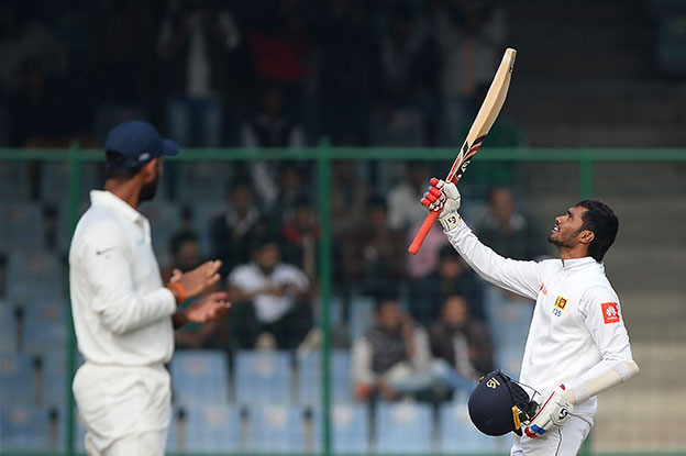 Sri Lankan batsman Dhananjaya de Silva raises his bat after completing his century (100 runs) during the fifth day of third Test cricket match between India and Sri Lanka at the Feroz Shah Kotla Cricket Stadium in New Delhi on Wednesday (AFP photo)