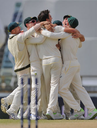 Australian players celebrate taking the Ashes series after winning the third Ashes cricket Test match against England in Perth on Monday (AFP photo by  Greg Wood)