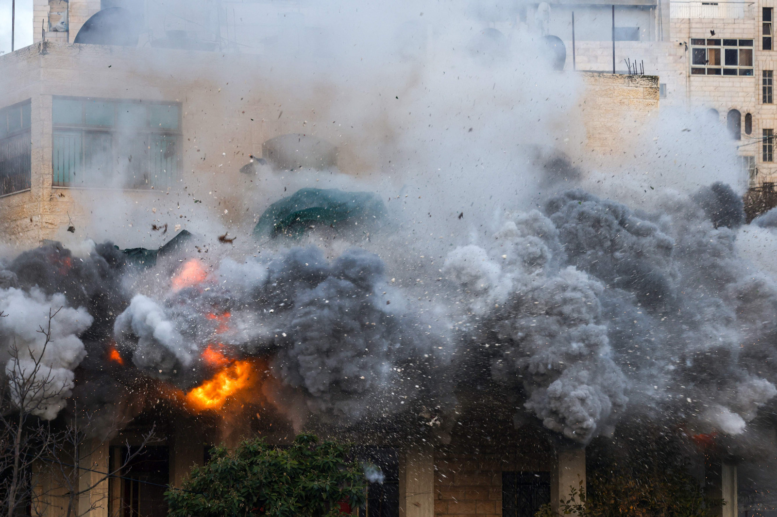 The house of a Palestinian man accused of an attack against Israelis in October 2024 in Jaffa, is blown up by Israeli security forces in Hebron, in the occupied west Bank on March 5, 2025 (AFP photo)