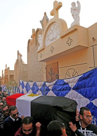 Relatives of a Christian woman who was killed in the bombing of Cairo’s main Coptic cathedral, carry her body to bury at the Mokattam Cemetery in Cairo, Egypt, on Monday (Reuters photo)