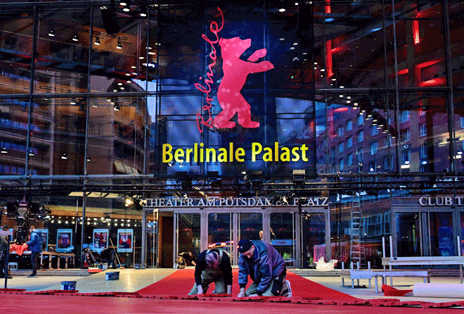 Workers lay the red carpet in front of the Berlinale Palace as preparations are under way for the 73rd Berlinale International Film Festival in Berlin on Tuesday (AFP photo by John Macdougall)