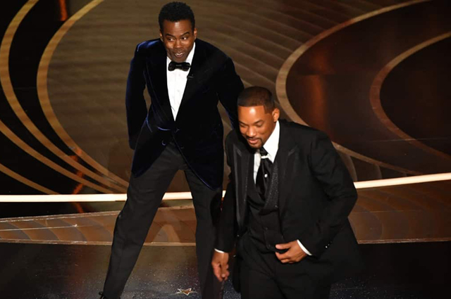 Actor Will Smith leaves the stage after he slaps Oscar host Chris Rock (left) during the 94th Oscars at the Dolby Theatre in Hollywood, California, on Monday (AFP photo)