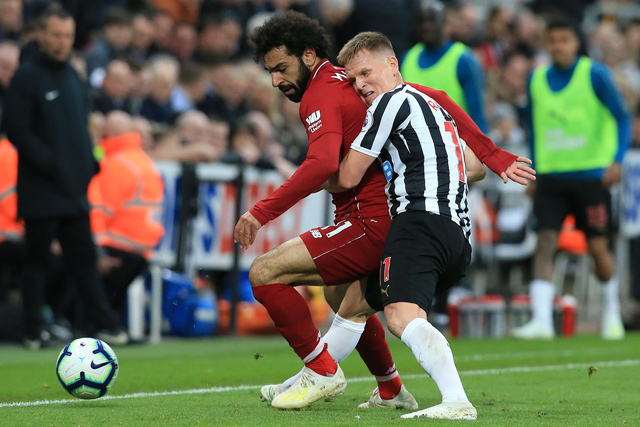 Liverpool’s Egyptian midfielder Mohamed Salah vies with Newcastle United’s Scottish midfielder Matt Ritchie (right) during their English Premier League football match in Newcastle-upon-Tyne, England, on Saturday  (AFP photo by Lindsey Parnaby)