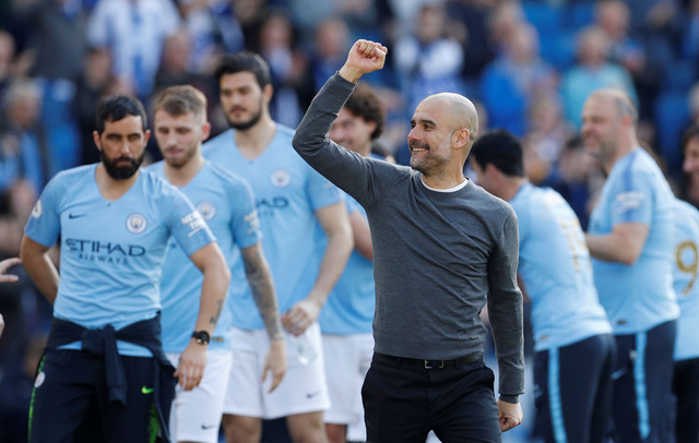 Manchester City manager Pep Guardiola celebrates winning the English Premier League in Brighton on Sunday  (Reuters photo by John Sibley)