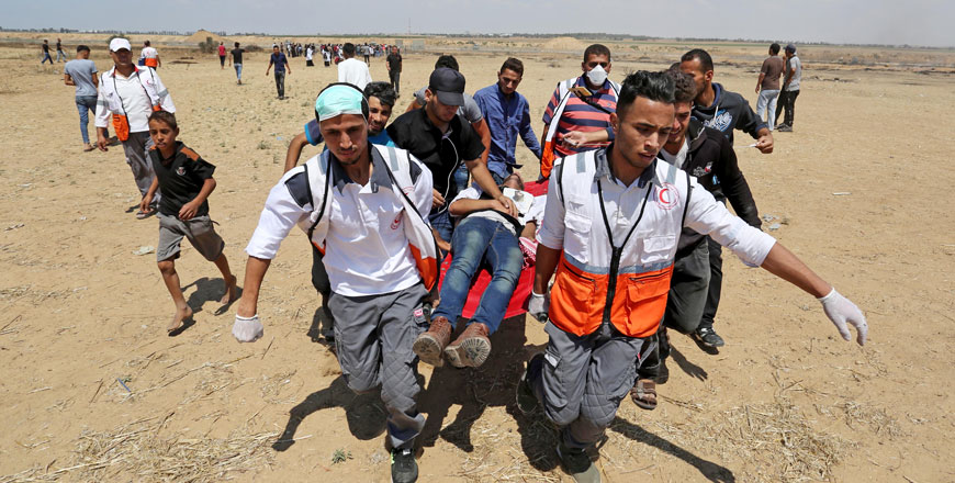 Palestinian paramedics carry an injured protester during a demonstration organised after Razan Al Najjar, 21, a female paramedic, was shot dead by Israeli forces while treating wounded demonstrators during Great March of Return protests in Khan Younis on Saturday (Anadolu Agency photo)