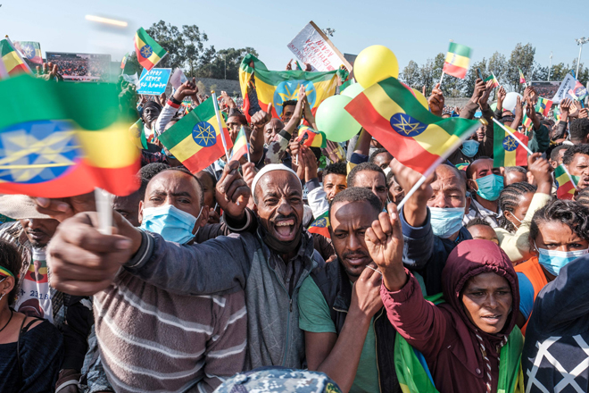 Demonstrators wave flags during a rally in Addis Ababa, Ethiopia, on Sunday, in support of the national defence forces (AFP photo)