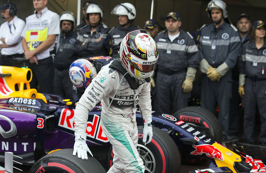 Mercedes driver Lewis Hamilton of Britain touches his front tyre after he clocked the fastest time in the qualifying session at the Monaco racetrack in Monaco on Saturday (AP photo by Gero Breloer)