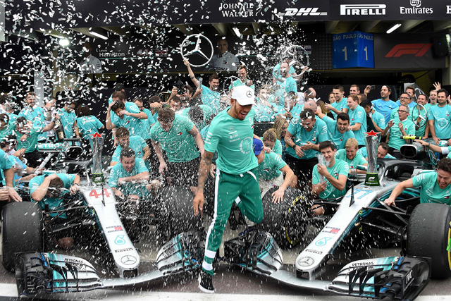 Mercedes’ British driver Lewis Hamilton (centre) celebrates with the Mercedes team after winning the F1 Brazil Grand Prix and taking the constructors title in Sao Paulo, Brazil, on Sunday (AFP photo by Evaristo Sa)