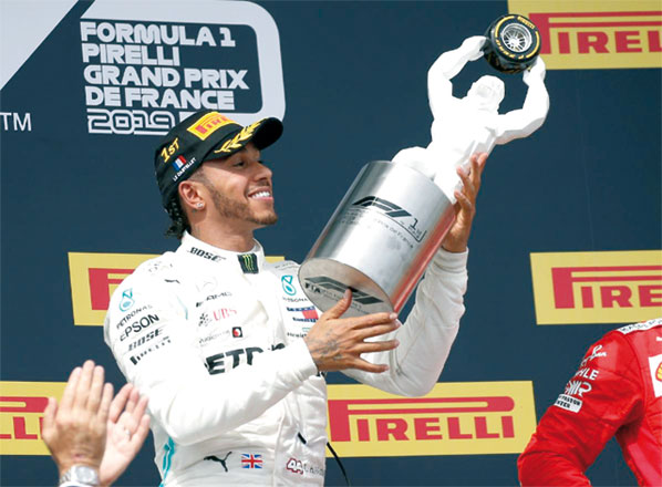 Mercedes’ Lewis Hamilton celebrates winning with the French Grand Prix trophy in Le Castellet, France, on Sunday (Reuters photo)