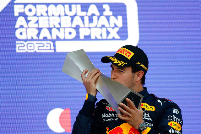 Red Bull’s Mexican driver Sergio Perez celebrates on the podium after winning the Formula One Azerbaijan Grand Prix in Baku on Sunday  (AFP photo by Maxim Shemetov)